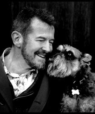 Portrait of author Adam Mars-Jones, with dog