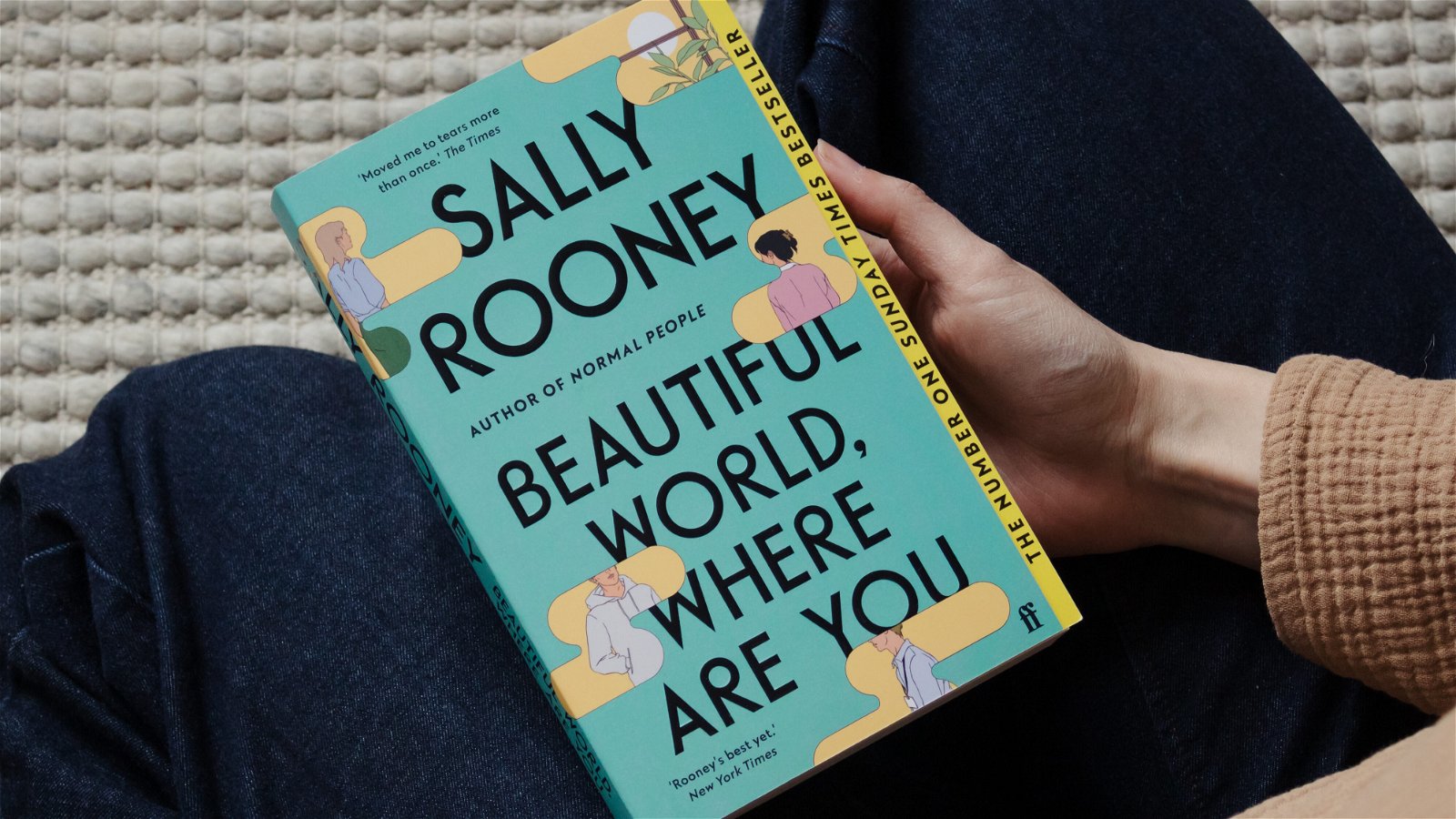 Woman holding Sally Rooney book