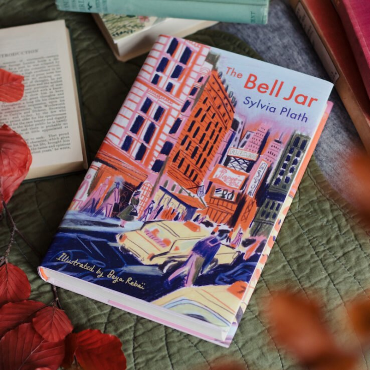 Illustrated version of The Bell Jar lying next to other books