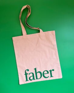 Faber tote bag on green background
