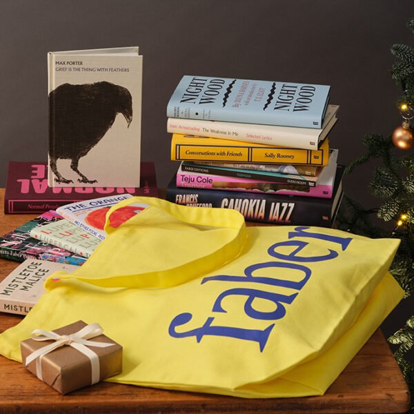 Faber books and products laid on table next to Christmas tree