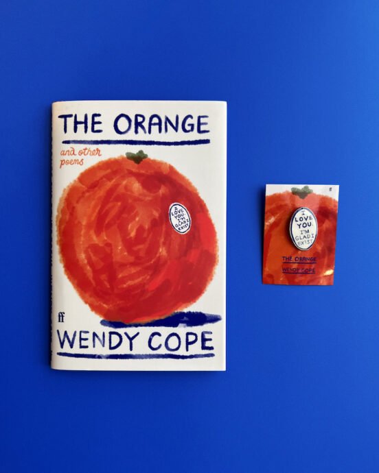 'The Orange' and pin badge on a blue background